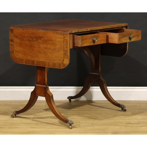 2094 - A 19th century mahogany sofa table, in the Regency taste, rounded rectangular top with fall leaves a... 