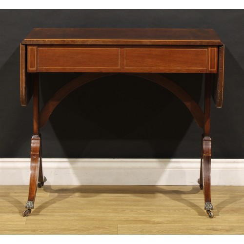 2094 - A 19th century mahogany sofa table, in the Regency taste, rounded rectangular top with fall leaves a... 