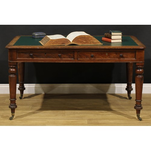 1949 - A Victorian mahogany library table, rounded rectangular top with inset writing surface above a pair ... 