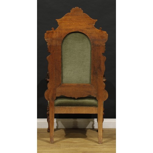 2354 - A Continental Baroque Revival armchair, stuffed-over upholstery, carved with Green Man masks, female... 