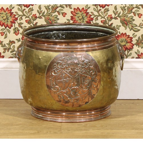 2355 - A Dutch brass and copper fireside fuel bin, embossed with an armorial, 34.5cm high, 38cm diameter, e... 