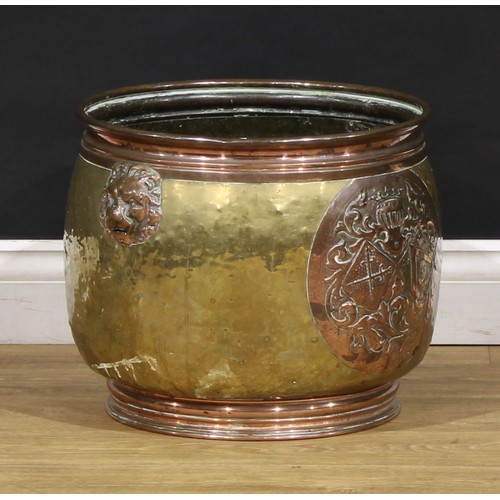 2355 - A Dutch brass and copper fireside fuel bin, embossed with an armorial, 34.5cm high, 38cm diameter, e... 