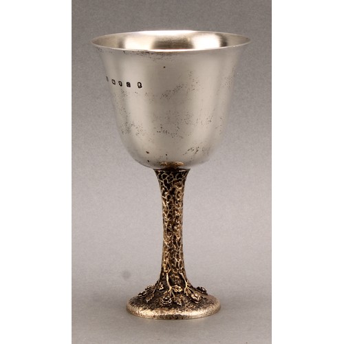 1052 - An Elizabeth II silver goblet, bell shaped bowl, silver gilt textured stem, the circular foot cast w... 