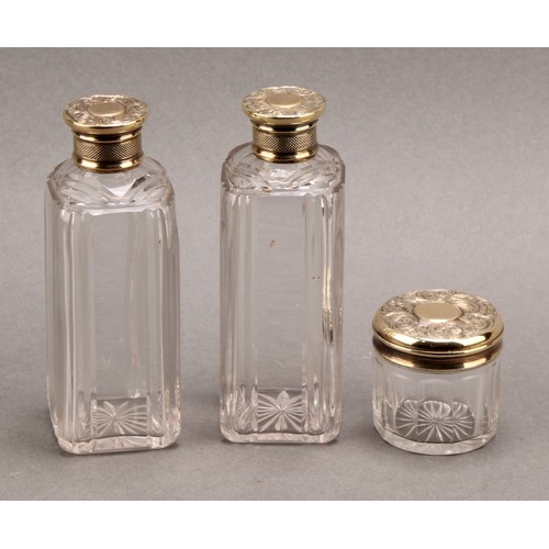 897 - A pair of William IV silver gilt mounted shaped rectangular scent bottles, the covers chased with fo... 