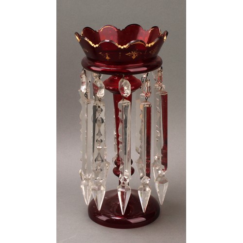 295 - A pair of Victorian ruby glass table or mantel lustres, each applied with gilt motifs, prismatic cut... 