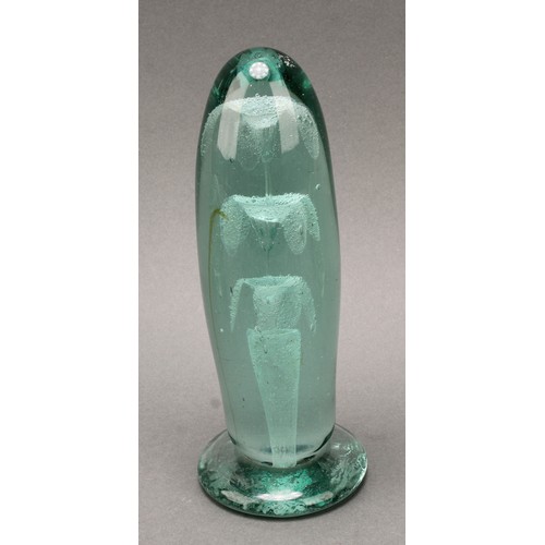 298 - A Victorian elongated green glass dump, flower inclusions issuing from a vase, spreading circular ba... 