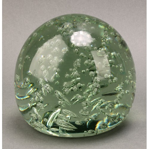 298 - A Victorian elongated green glass dump, flower inclusions issuing from a vase, spreading circular ba... 