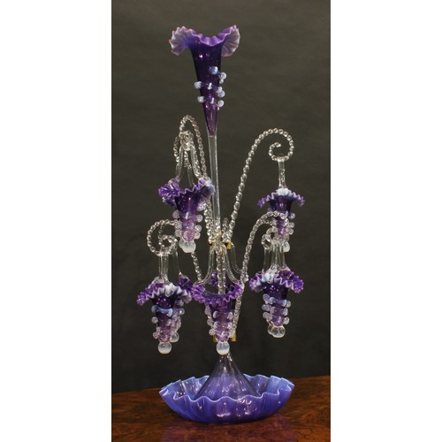 286 - A large Victorian amethyst glass table epergne, the central flared trumpet, applied with vaseline sp... 