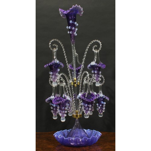 286 - A large Victorian amethyst glass table epergne, the central flared trumpet, applied with vaseline sp... 