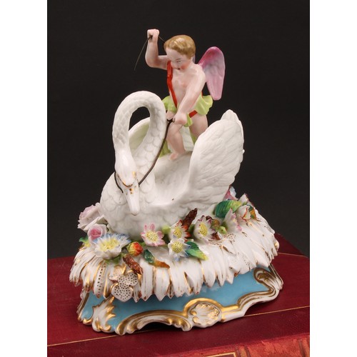 217 - A 19th century Jacob Petit, Paris, porcelain box and cover, Cupid riding a swan, on an oval bed of f... 