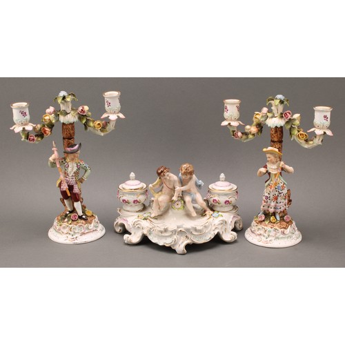 248 - A pair of Continental porcelain figural two branch candelabra, as a gallant and his companion, decor... 