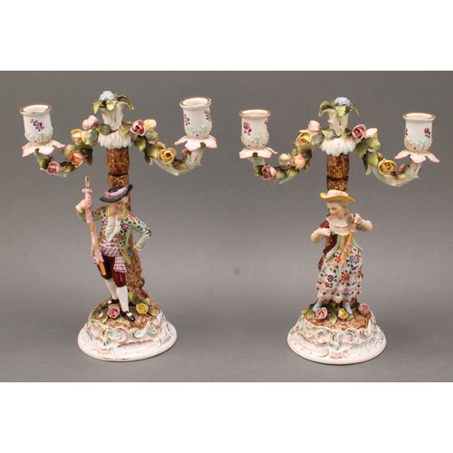 248 - A pair of Continental porcelain figural two branch candelabra, as a gallant and his companion, decor... 