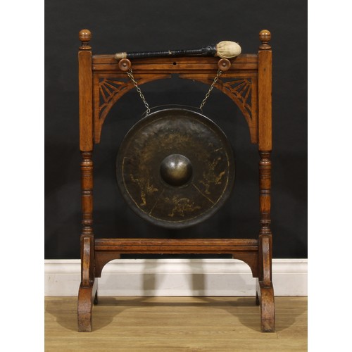 2465 - An Arts & Crafts period oak floor-standing gong, 89.5cm high, 59cm wide, 43cm deep, the parcel-gilt ... 