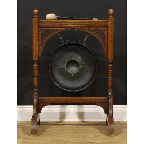 2465 - An Arts & Crafts period oak floor-standing gong, 89.5cm high, 59cm wide, 43cm deep, the parcel-gilt ... 