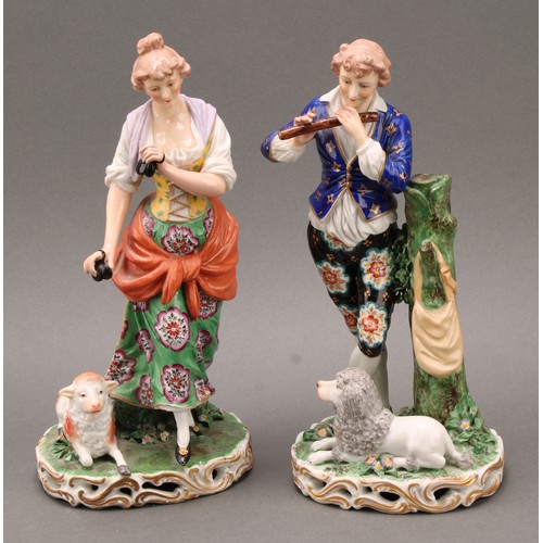 250 - A pair of French porcelain figures, of musicians, he playing the flute with a dog at his feet, she p... 