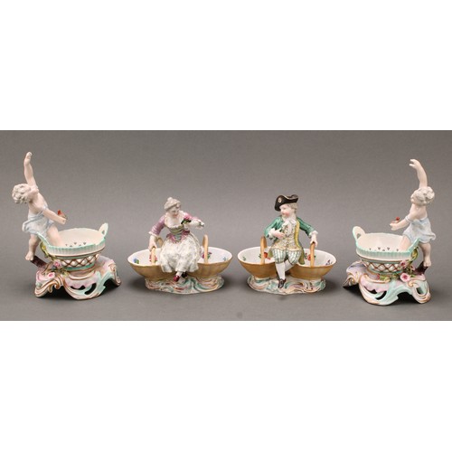 253 - A pair of German porcelain figural table salts, of a gallant and companion, each seated between two ... 