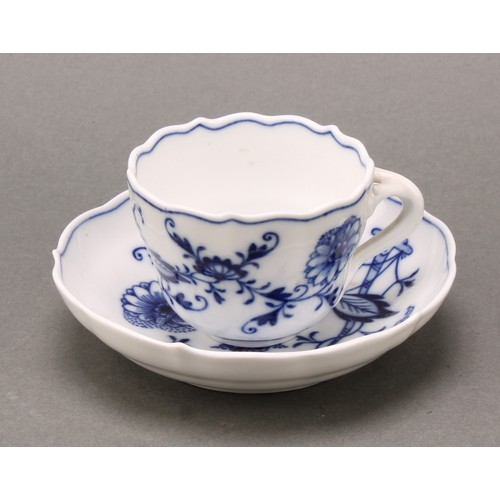 238 - A Meissen Onion pattern teacup and saucer, 10.5cm diameter, crossed swords mark in underglaze blue, ... 