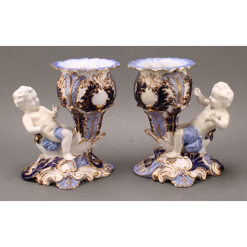 89 - A pair of 19th century Copeland figural vases, modelled as putti sitting astride a cornucopia, one h... 