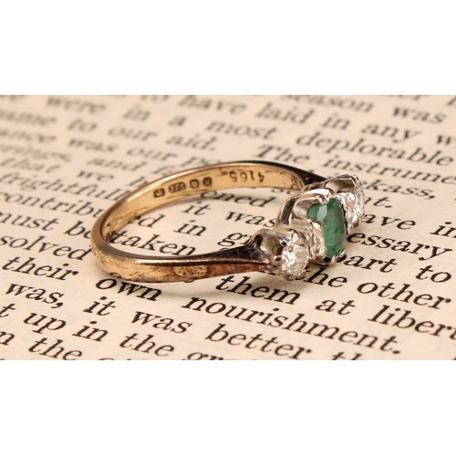 1256 - An emerald and diamond ring, central oval mid green emerald, approx 0.25ct, flanked by round brillia... 