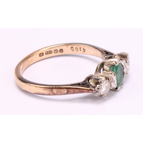 1256 - An emerald and diamond ring, central oval mid green emerald, approx 0.25ct, flanked by round brillia... 