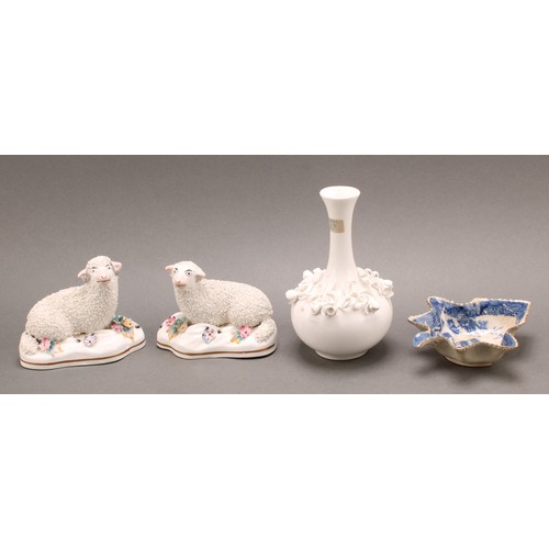 96 - A pair of early 19th century Staffordshire porcelain models, of a sheep and ram, the shaped bases ap... 