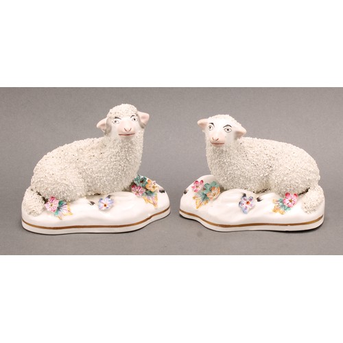 96 - A pair of early 19th century Staffordshire porcelain models, of a sheep and ram, the shaped bases ap... 