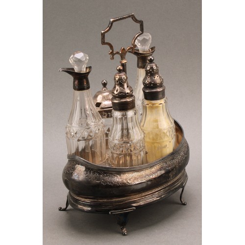 773 - A George III silver five bottle boat shaped cruet stand, central carrying handle, silver mounted cut... 