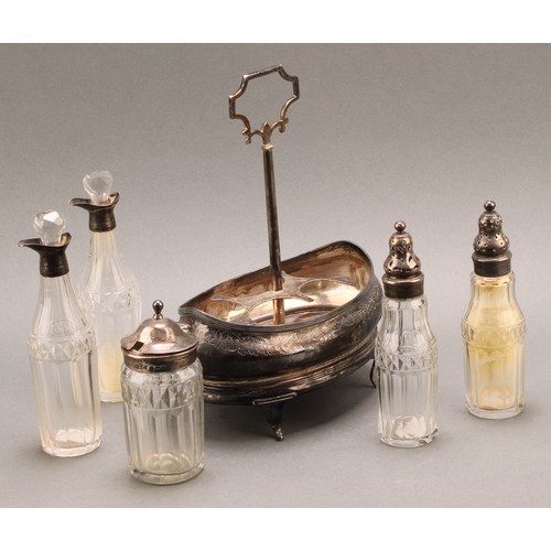 773 - A George III silver five bottle boat shaped cruet stand, central carrying handle, silver mounted cut... 