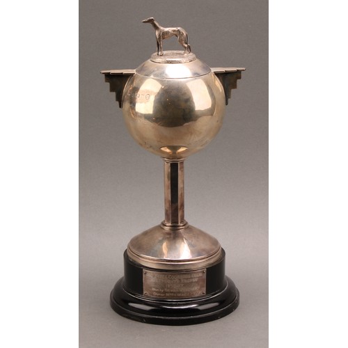 805 - A George V Art Deco silver two handled globular trophy and cover, angular handles, octagonal column,... 