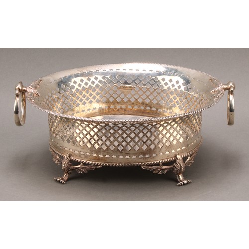 763 - A George II style oval cake or bread basket, pierced with trellis, swing handles, scroll feet cast w... 