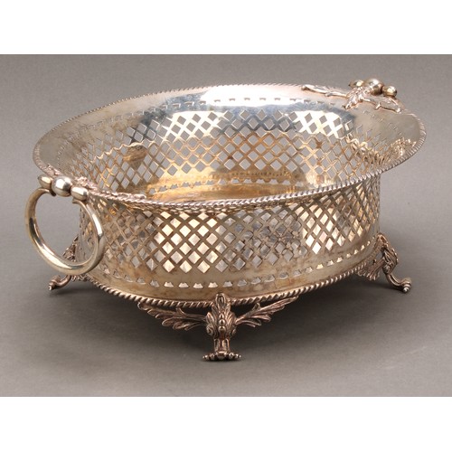 763 - A George II style oval cake or bread basket, pierced with trellis, swing handles, scroll feet cast w... 