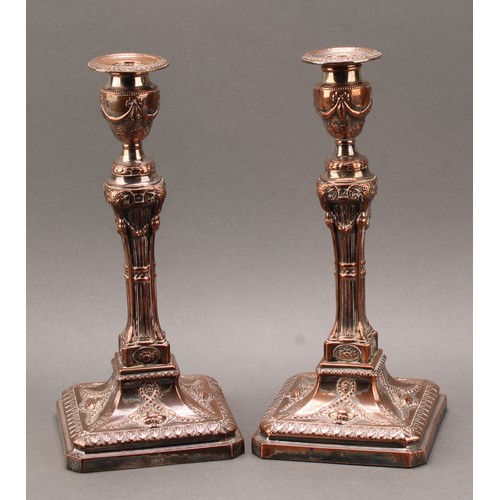 679 - A pair of George III Neo Classical Old Sheffield Plate table candlesticks, campana sconces, spreadin... 