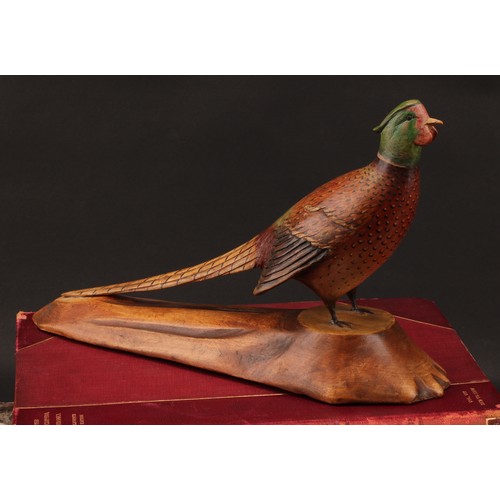 1957 - Folk Art - a polychrome decorated softwood model, carved as a pheasant, naturalistic base stamped L.... 