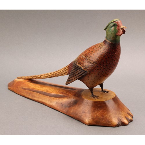 1957 - Folk Art - a polychrome decorated softwood model, carved as a pheasant, naturalistic base stamped L.... 