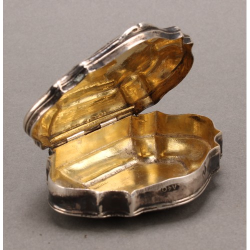 976 - An 18th century Continental silver shell shaped snuff box, hinged cover engraved with a scantily cla... 