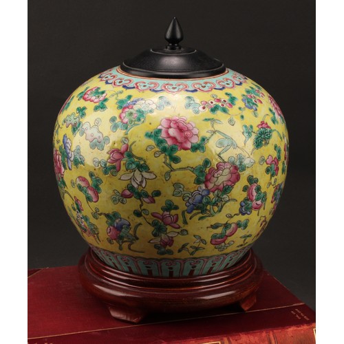 1290 - A 19th century Chinese ovoid ginger jar on stand, decorated in the famille rose tradition on a yello... 