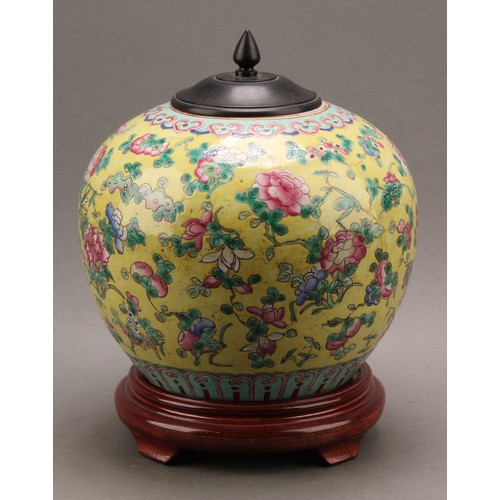 1290 - A 19th century Chinese ovoid ginger jar on stand, decorated in the famille rose tradition on a yello... 