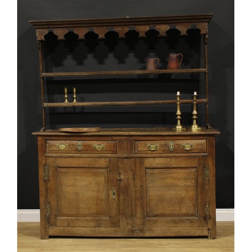 2416 - An 18th century oak dresser, moulded cornice above a pair of shelves, the projecting base with two f... 