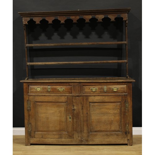 2416 - An 18th century oak dresser, moulded cornice above a pair of shelves, the projecting base with two f... 