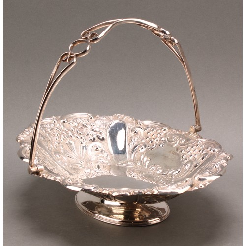 849 - A late Victorian silver swing-handled shaped oval pedestal basket, chased throughout with flowers an... 