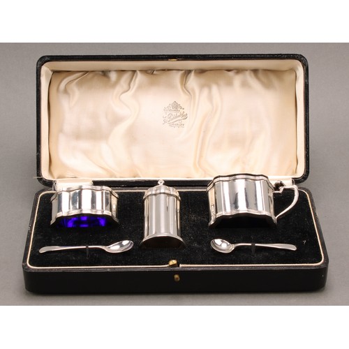 826 - A George V silver three piece serpentine condiment set, comprising mustard, pepper and salt, the pep... 