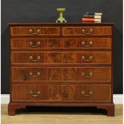 1501 - A George III flame mahogany chest, of two short and four long graduated cockbeaded drawers, outlined... 