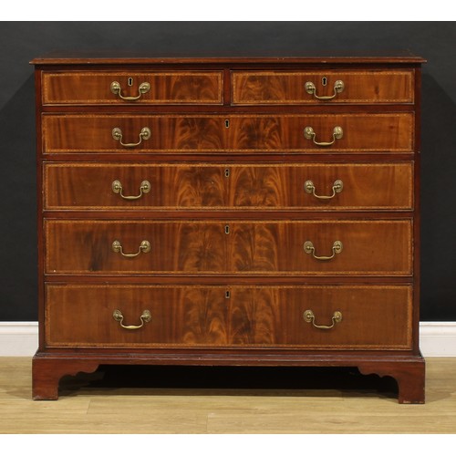 1501 - A George III flame mahogany chest, of two short and four long graduated cockbeaded drawers, outlined... 