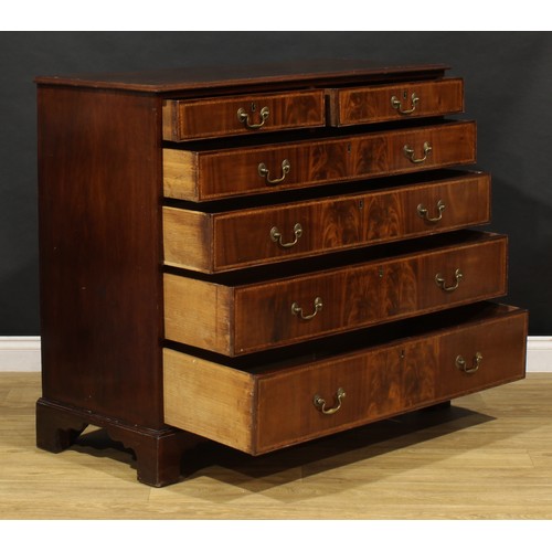 1501 - A George III flame mahogany chest, of two short and four long graduated cockbeaded drawers, outlined... 