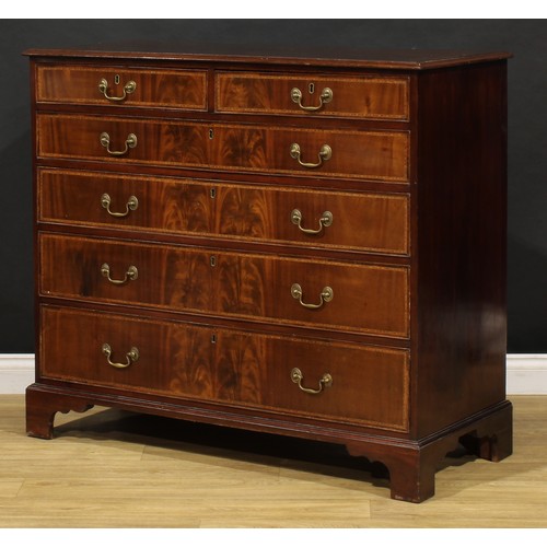 1501 - A George III flame mahogany chest, of two short and four long graduated cockbeaded drawers, outlined... 