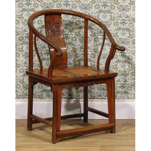 1890 - A Chinese elm horseshoe chair, the splat carved with a figure amongst prunus trees, 95cm high, 65.5c... 