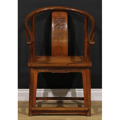 1890 - A Chinese elm horseshoe chair, the splat carved with a figure amongst prunus trees, 95cm high, 65.5c... 