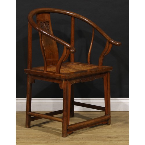 1890 - A Chinese elm horseshoe chair, the splat carved with a figure amongst prunus trees, 95cm high, 65.5c... 