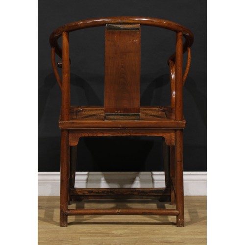 1890 - A Chinese elm horseshoe chair, the splat carved with a figure amongst prunus trees, 95cm high, 65.5c... 