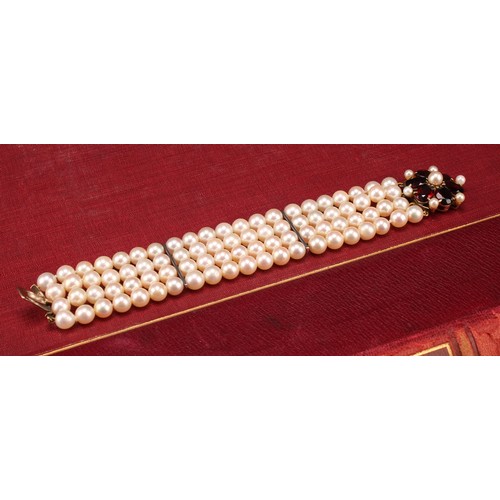 1209 - A garnet and cream cultured pearl bracelet with pink overtones, four strand with two bar dividers wi... 